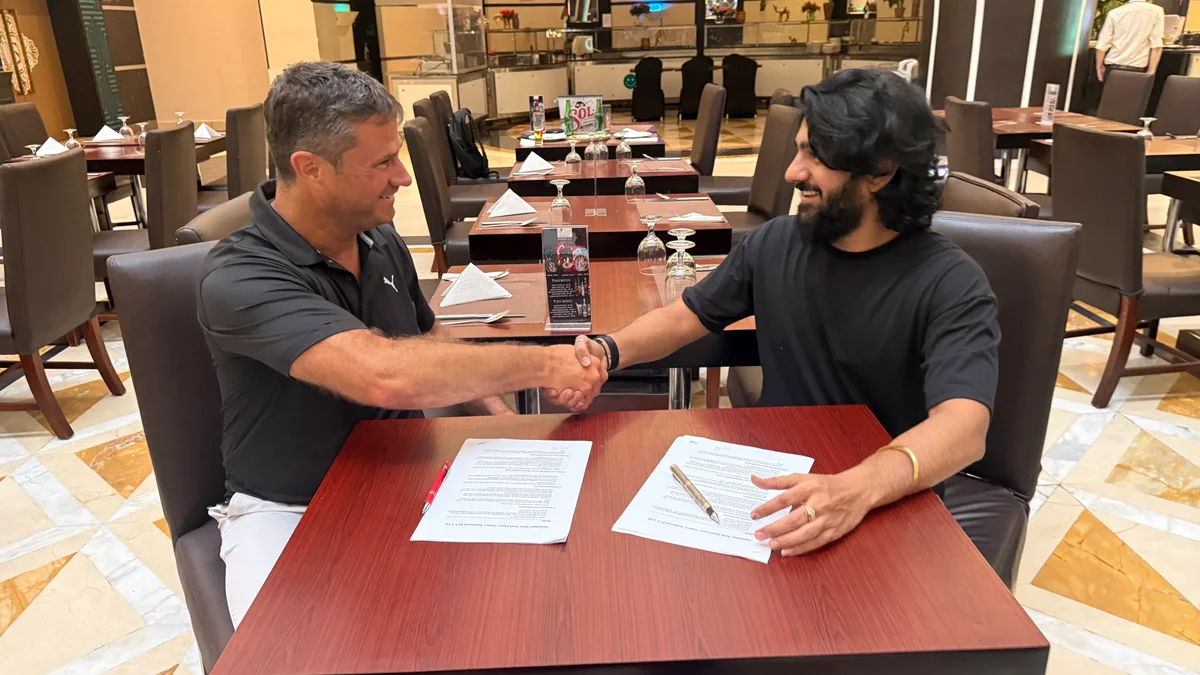 Groovy Web CEO Krunal Panchal and Mr. Dani Wattenhofer of Swiss Trust Layer shake hands over the signed MOU in Dubai